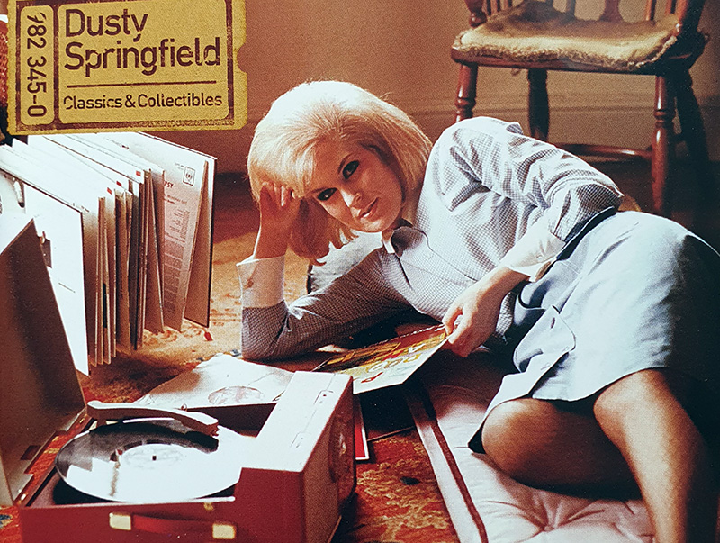 Dusty Springfield lying on the floor playing records