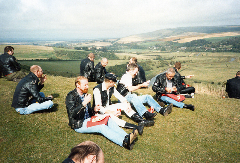 A group of men in leather sitting on the Sussex Downs