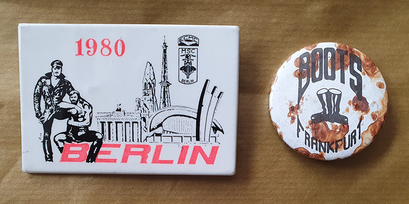 Two pin badges with the words 1980 Berlin and Boots Frankfurt on them