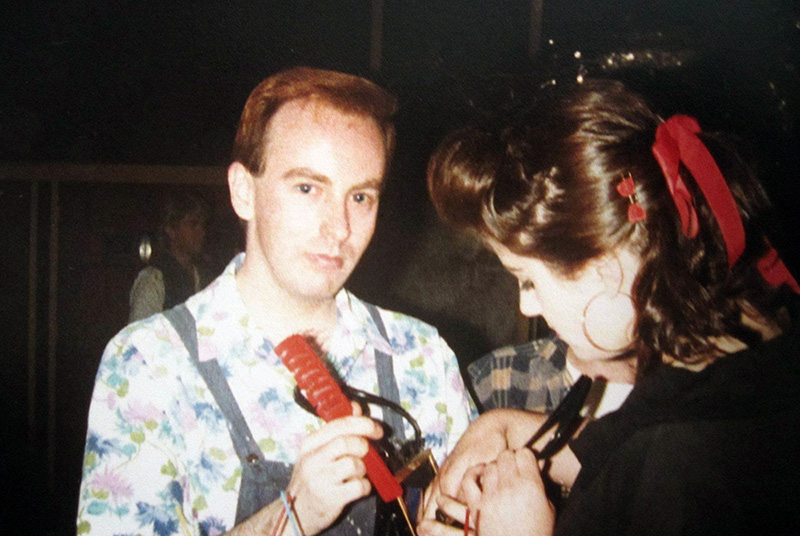 Two people in a club, one looking at the camera