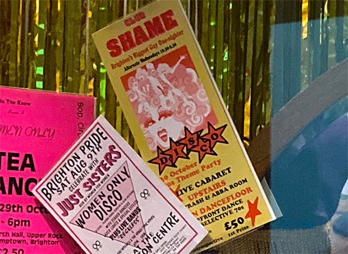 Three flyers in front of a gold curtain