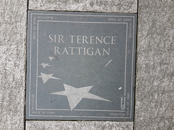 Square stone with the words: Sir Terence Rattigan and some stars engraved in it