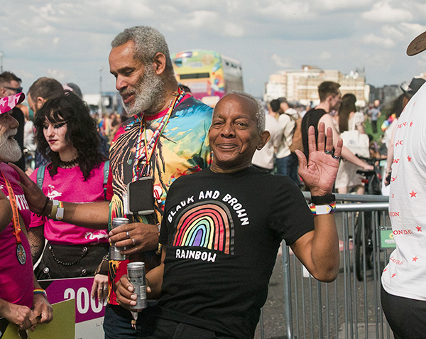 Two men, one waving at the camera